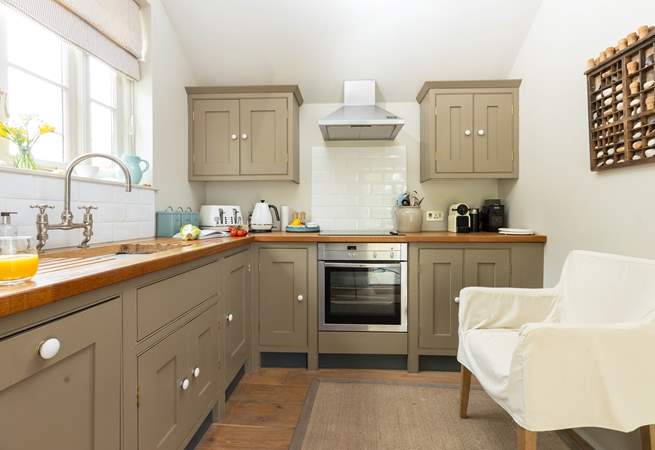The kitchen is light and airy with the door out onto the terrace. 