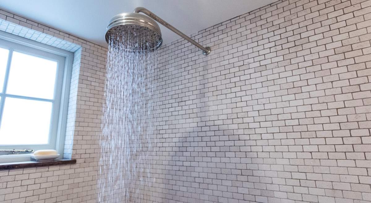 With a drench head shower. 