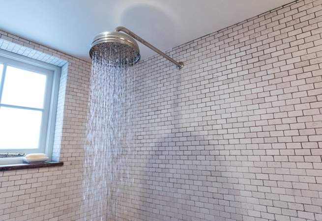 With a drench head shower. 