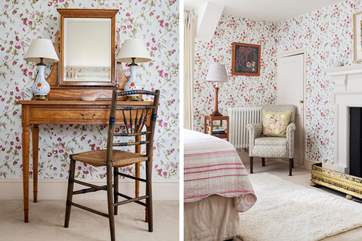 A beautiful room decorated in pretty sweet-pea wallpaper.