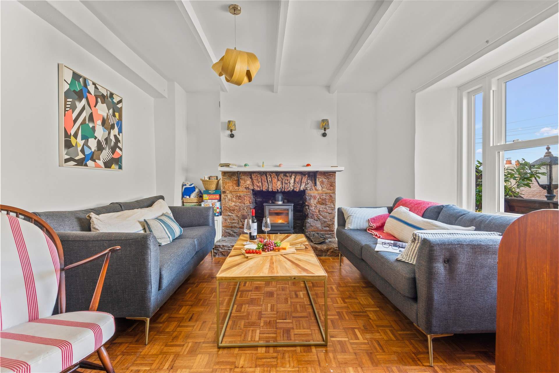 The bright and airy sitting-room. Please note, there is now a brand new Smart TV situated on the wall to the left of the wood-burner.