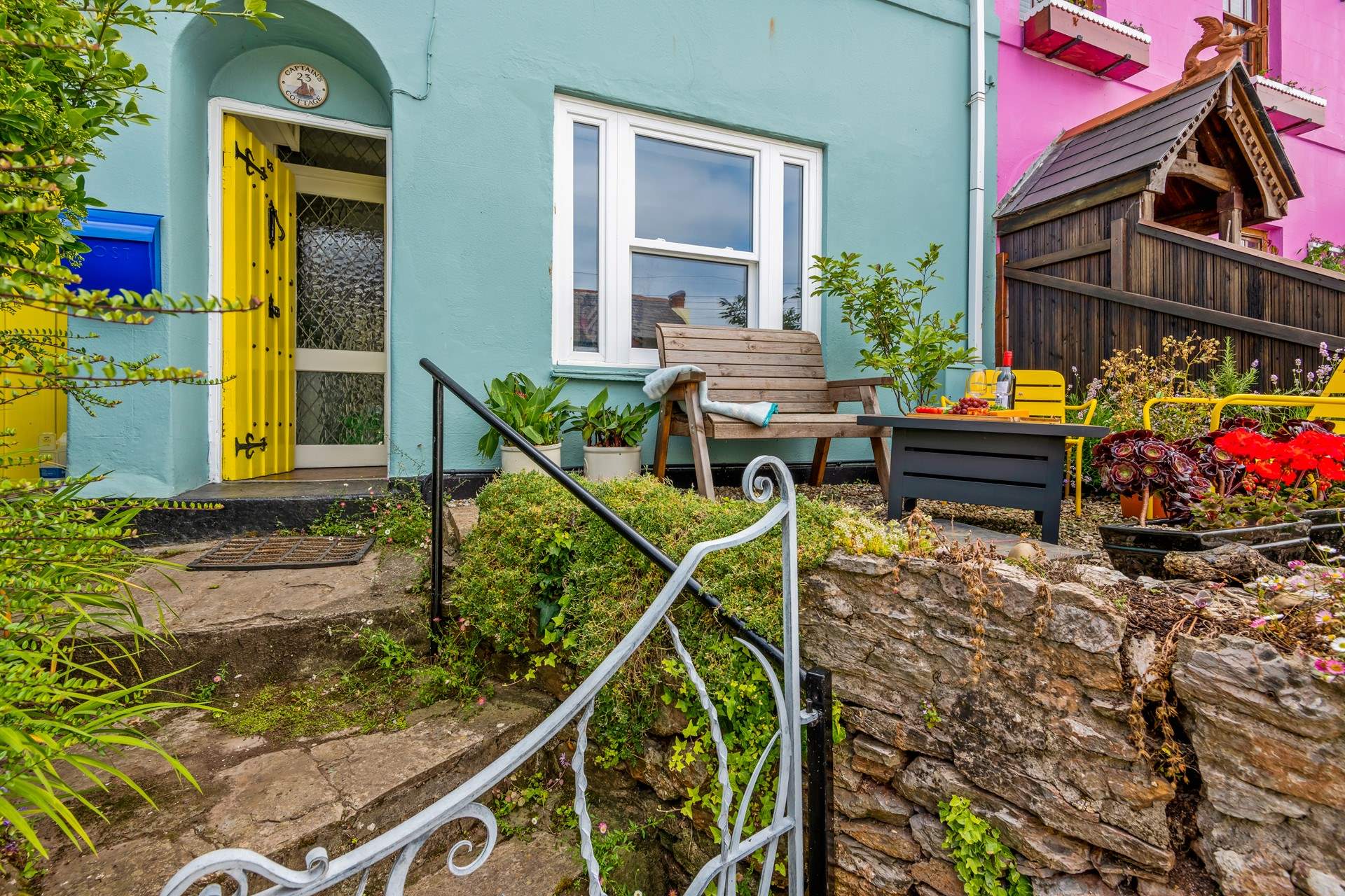 Captains Cottage is a beautiful cottage raised up from the street, perched perfectly for watching the hustle and bustle.