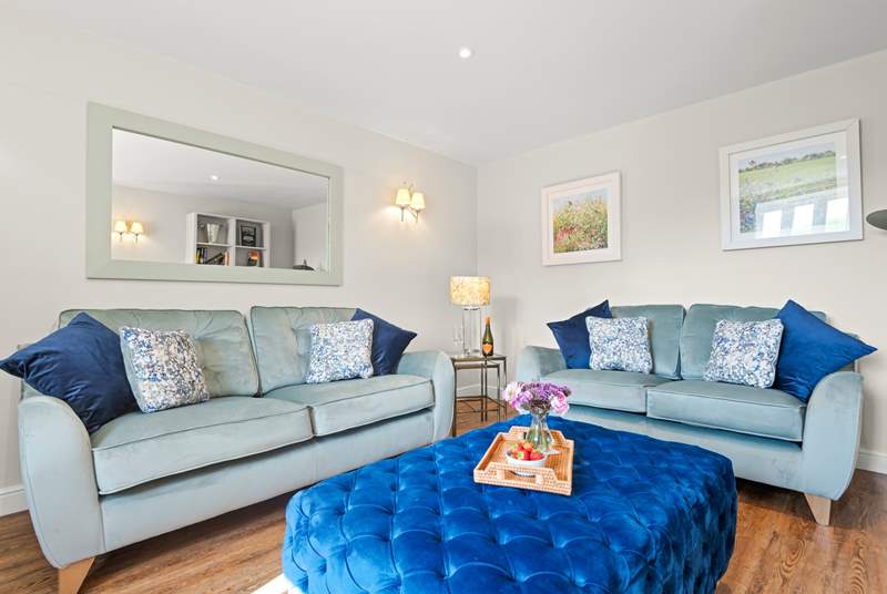 Snuggle up on one of the two sofas - there is plenty of space to relax here.