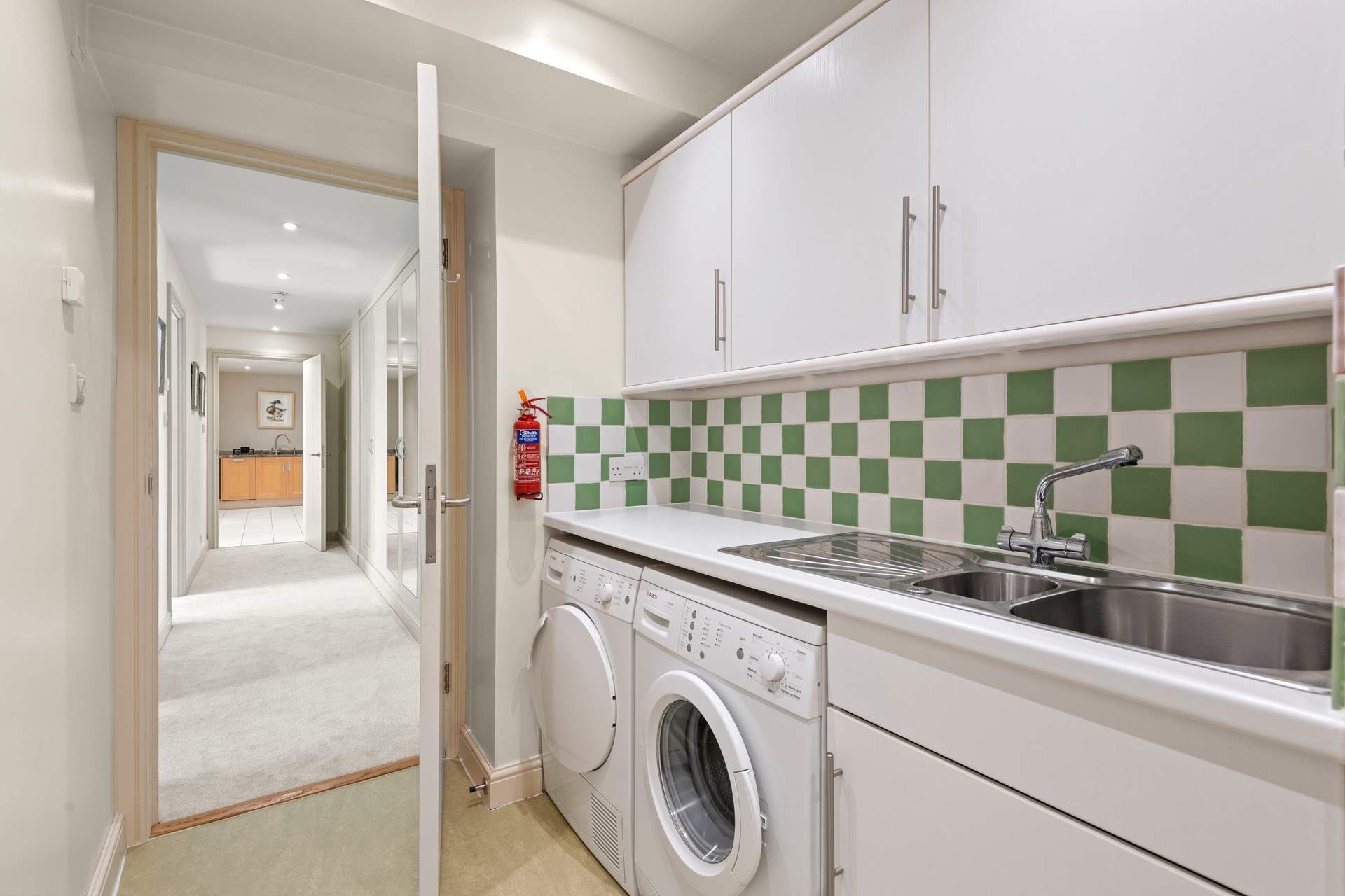 The handy utility-room houses the washing machine and tumble-drier.