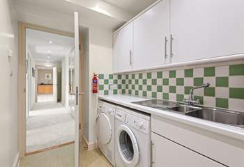The handy utility-room houses the washing machine and tumble-drier.