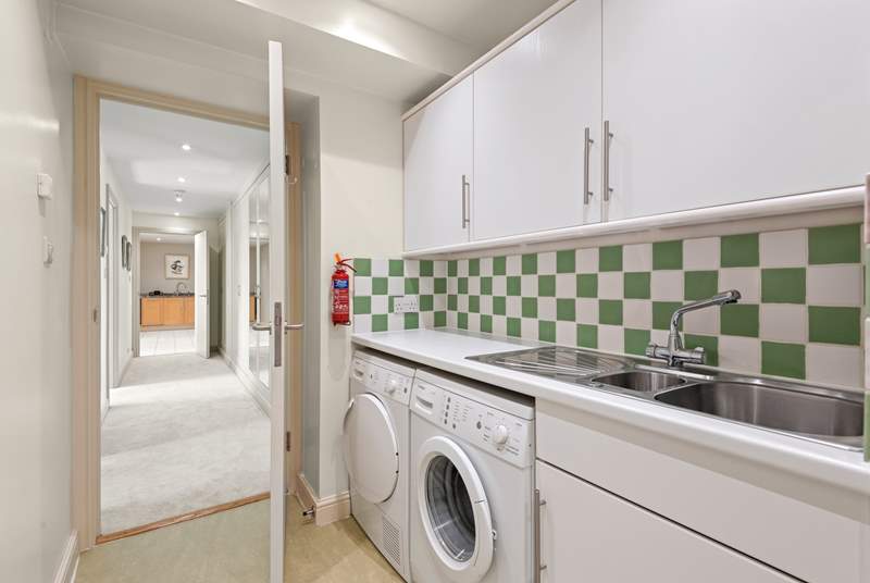 The handy utility-room houses the washing machine and tumble-drier.