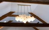 Uber trendy light fittings sit alongside the original beams, a marriage of old and new.  - Thumbnail Image