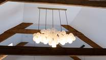 Uber trendy light fittings sit alongside the original beams, a marriage of old and new. 