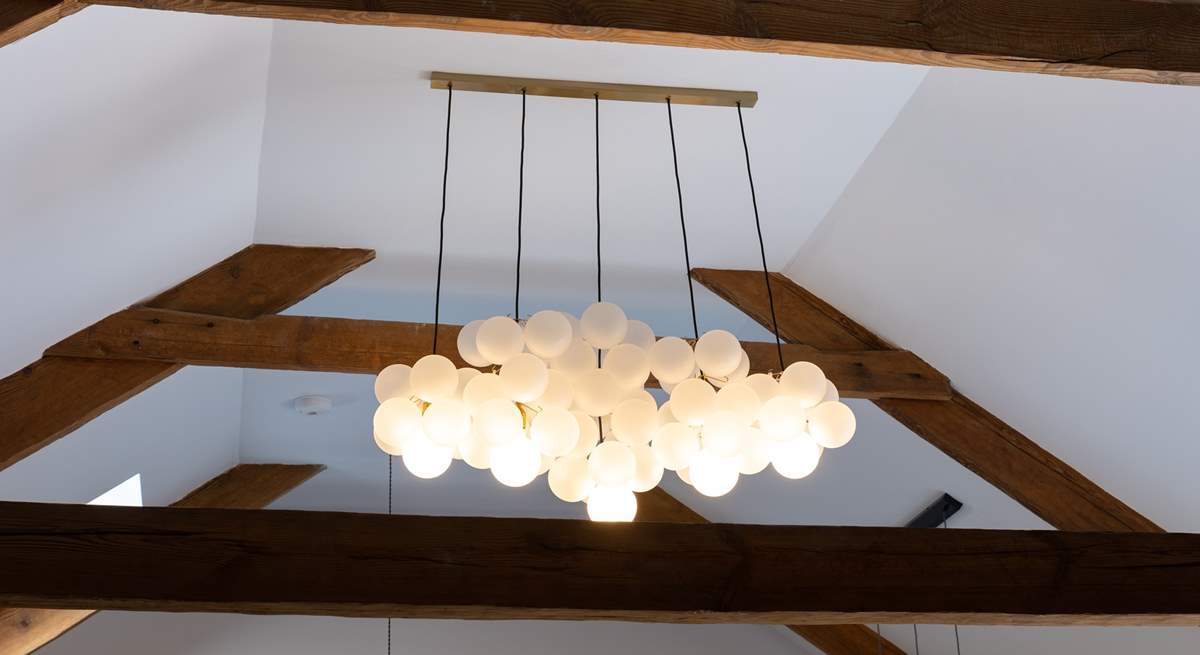 Uber trendy light fittings sit alongside the original beams, a marriage of old and new. 