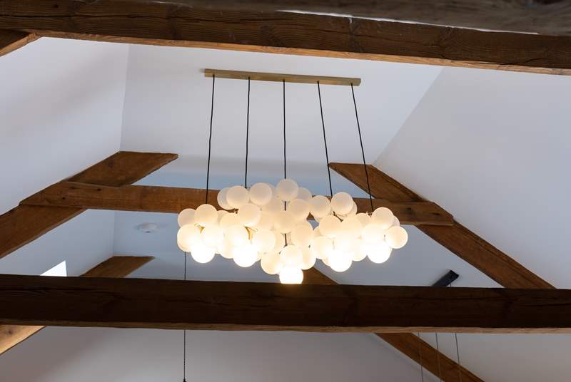 Uber trendy light fittings sit alongside the original beams, a marriage of old and new. 