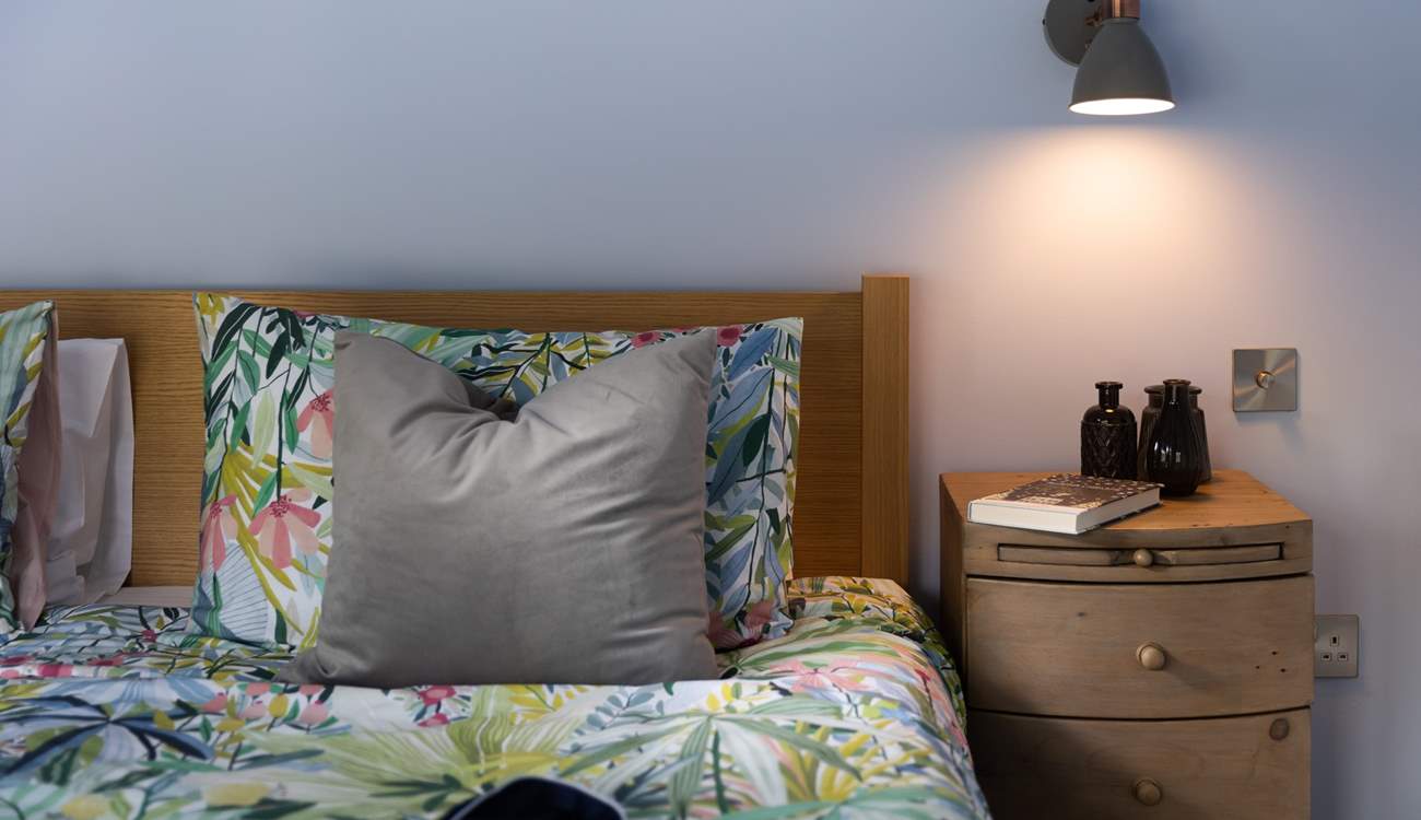 The beautifully recycled bedside cabinets have a nifty little pull out table. 