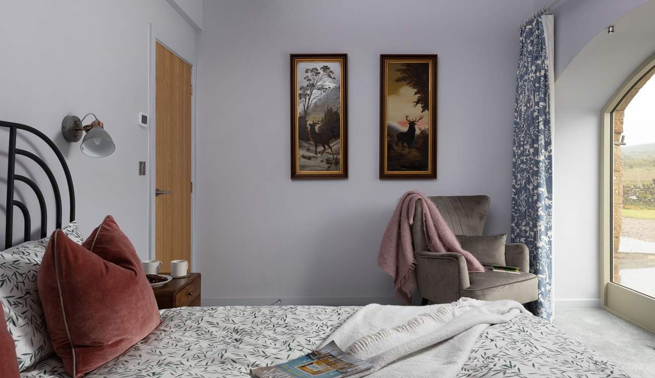 King-size bedroom 2 showcases vintage artwork and full width French windows. 