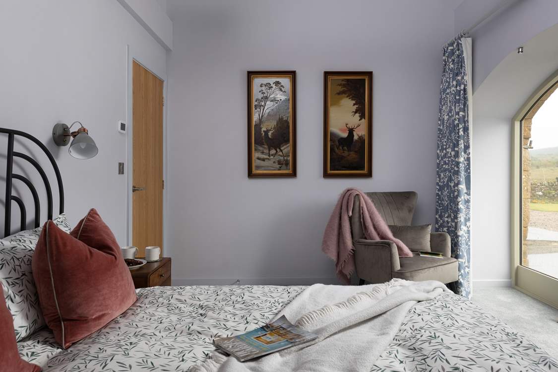 King-size bedroom 2 showcases vintage artwork and full width French windows.