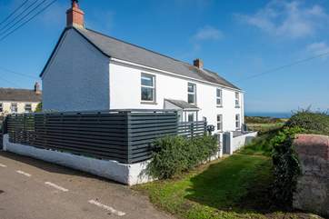 Contemporary fencing creates a private sun-trap where you can glimpse the twinkling ocean.