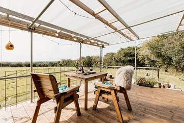 Or outside on the sheltered decking as sunlight seeps through.
