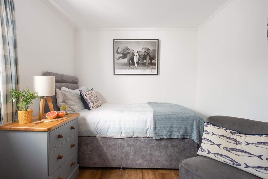 The single room with soft linens and a cosy throw.