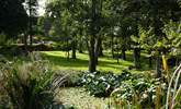 The tranquil communal orchard with pond, is the perfect spot to take a hot drink, sit and enjoy the sound of the morning bird song. - Thumbnail Image