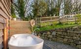 The secluded outdoor bathtub is the perfect place to soak and enjoy the blissful surroundings. - Thumbnail Image