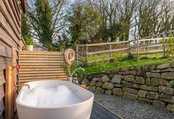 The secluded outdoor bathtub is the perfect place to soak and enjoy the blissful surroundings.