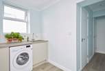 A handy utility area is great for holiday laundry which leads through to the shower-room and cloakroom.