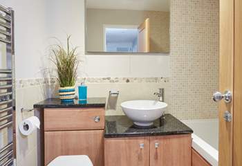 Modern family bathroom with a hand shower attachment is situated on the ground floor next door to the children's room.