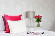 The main bedroom with plush cushions.