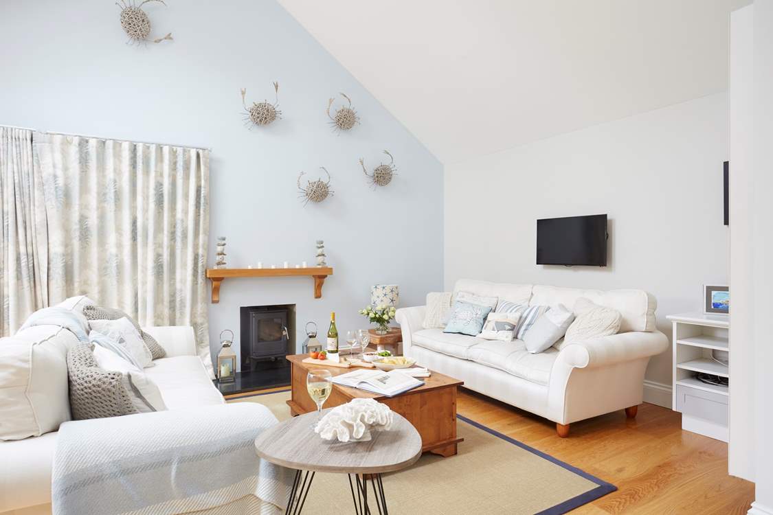 Large sofas and ample space, the living-room is a lovely space for the family to come together and catch up or plan the day ahead. The wood-burner is ornamental and not for guests' use.