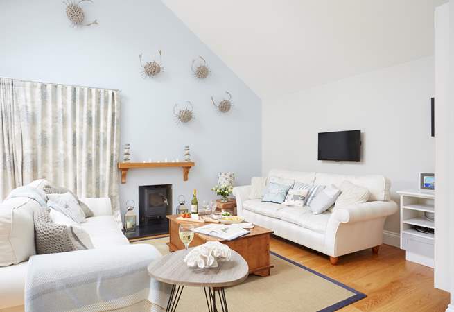 Large sofas and ample space, the living-room is a lovely space for the family to come together and catch up or plan the day ahead. The wood-burner is ornamental and not for guests' use.