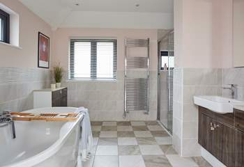 The en suite bathroom in the main suite has both a free-standing bath and shower, and double wash-basins.