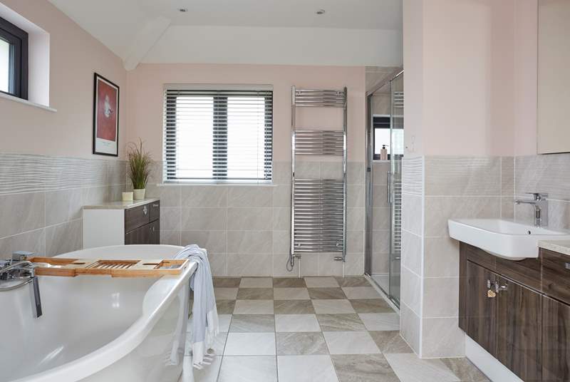 The en suite bathroom in the main suite has both a free-standing bath and walk in shower, and double wash-basins.