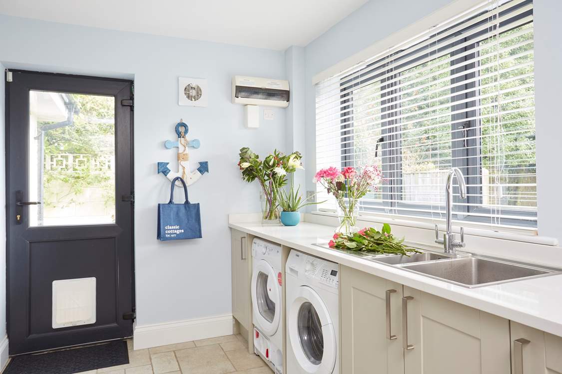 The utility-room access from the side of the house or through the kitchen.