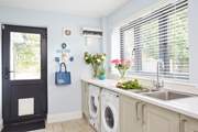 The utility-room access from the side of the house or through the kitchen.