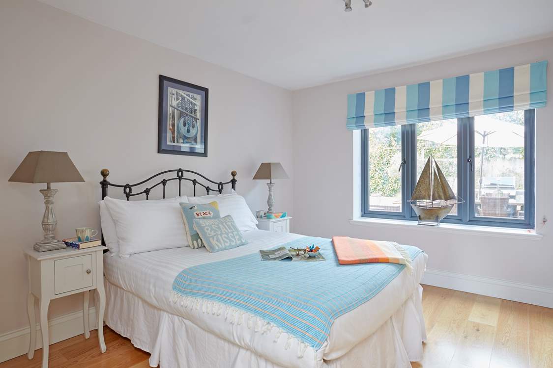Bedroom 2 on the ground floor with a double bed and view out to the back garden.