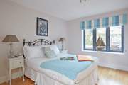 Bedroom 2 on the ground floor with a double bed and view out to the back garden.