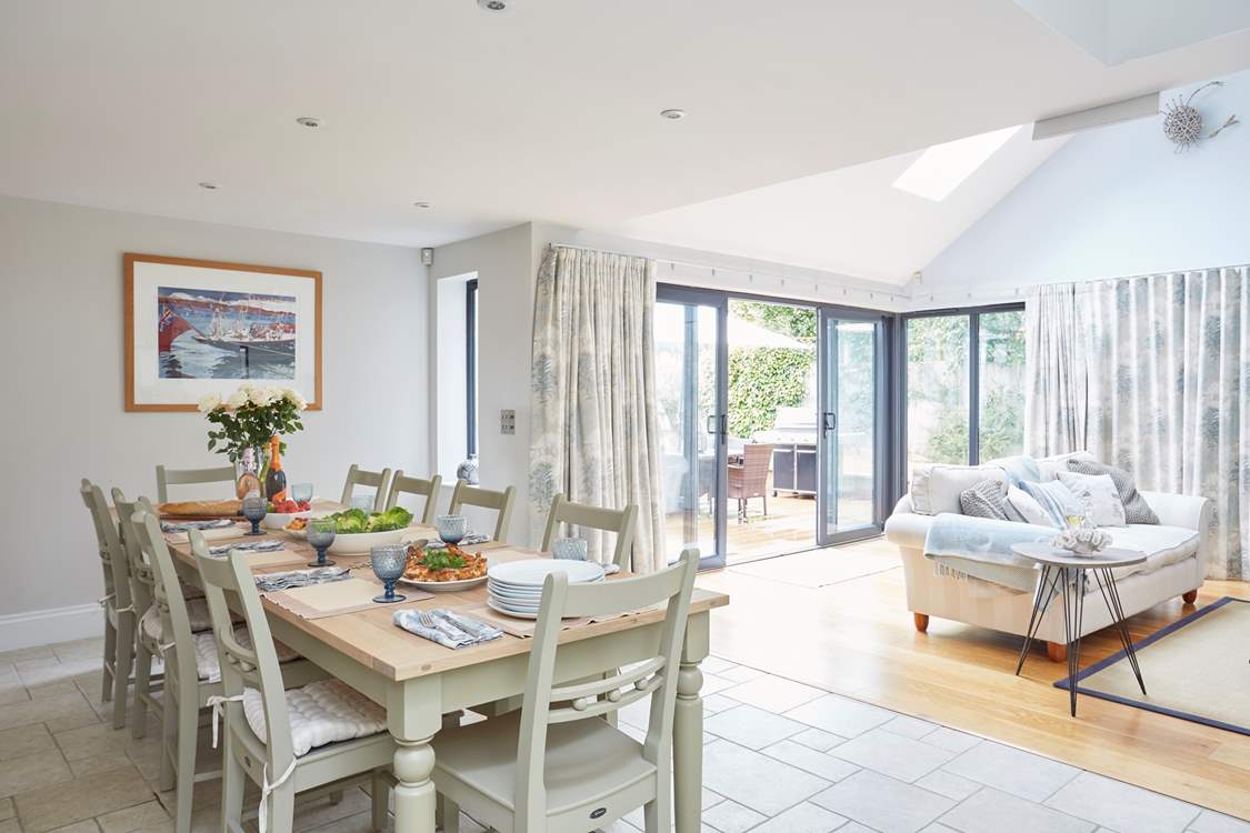 Open plan dining and living area with a view to the outside patio and entertaining space.