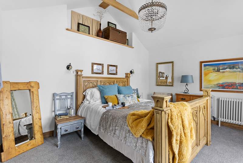 There are two bedrooms, this one offers space and grandeur and a chandelier! 
