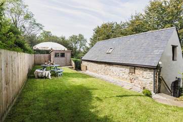 The garden sits to the rear of the barn and is accessed via a flight of steps.