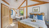 The bedroom enjoys a free-standing bath, for those luxurious holiday soaks.