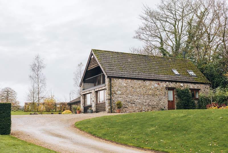 Head up the driveway and find The Cottage at Ford Barton, with the parking area adjacent to the door.