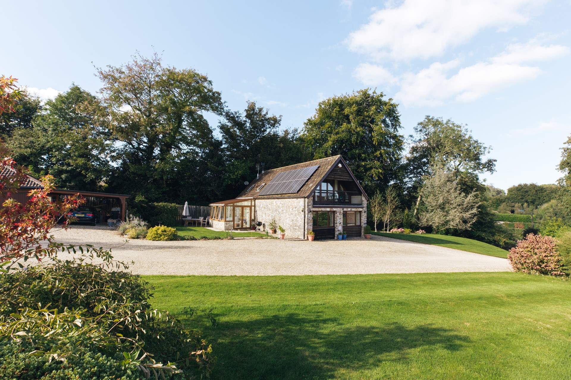 The private area of garden lies to the side of the cottage by the conservatory.