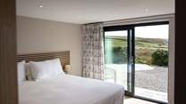 Enjoy panoramic sea views and access to the patio from the lower ground floor.