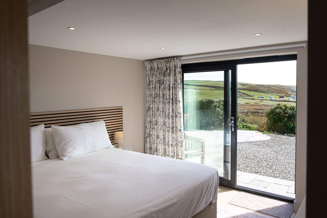 Enjoy panoramic sea views and access to the patio from the lower ground floor.