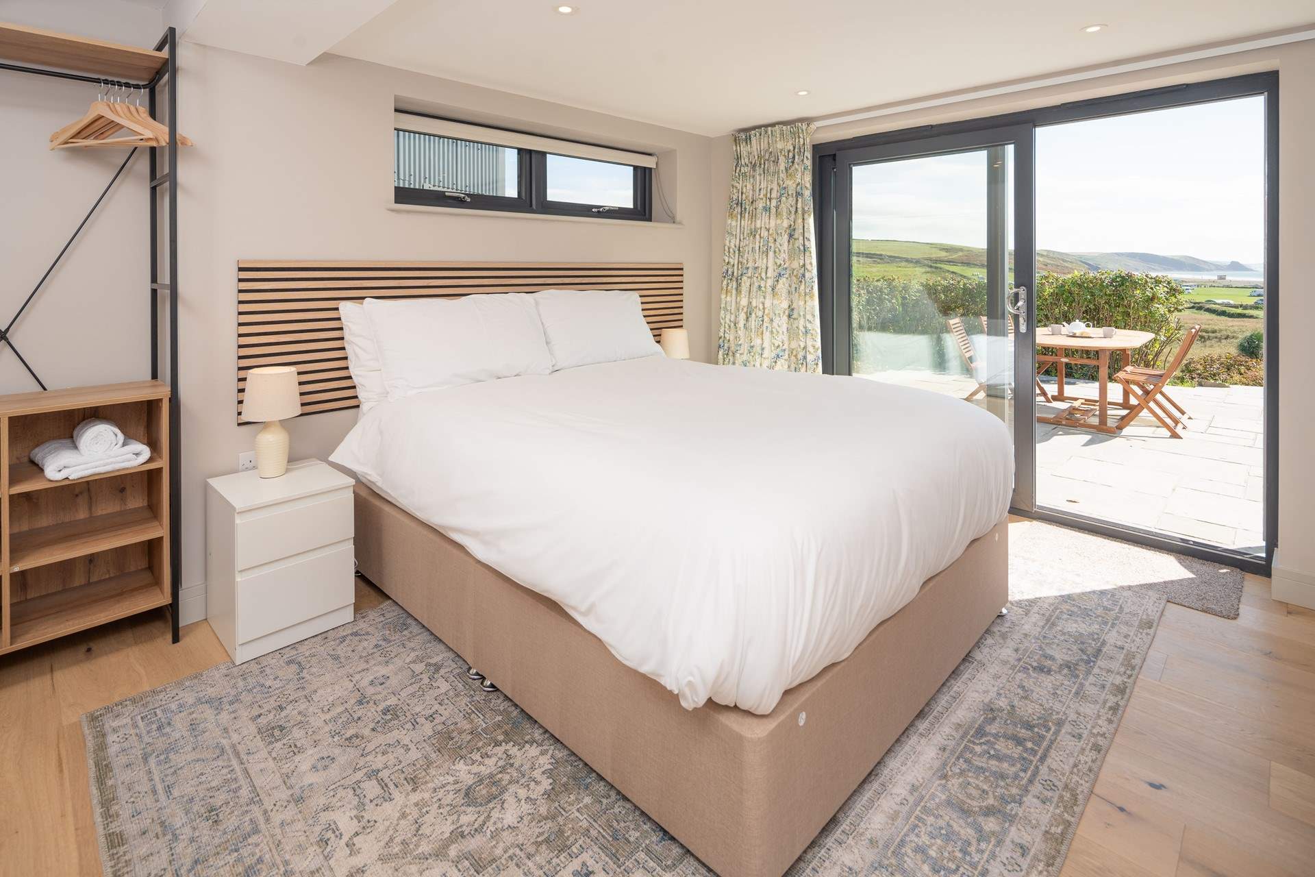 This lower ground floor bedroom has captivating sea views and access to the patio. Enjoy stargazing and watching the moonlight shimmering on the sea.