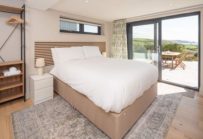 This lower ground floor bedroom has captivating sea views and access to the patio. Enjoy stargazing and watching the moonlight shimmering on the sea.