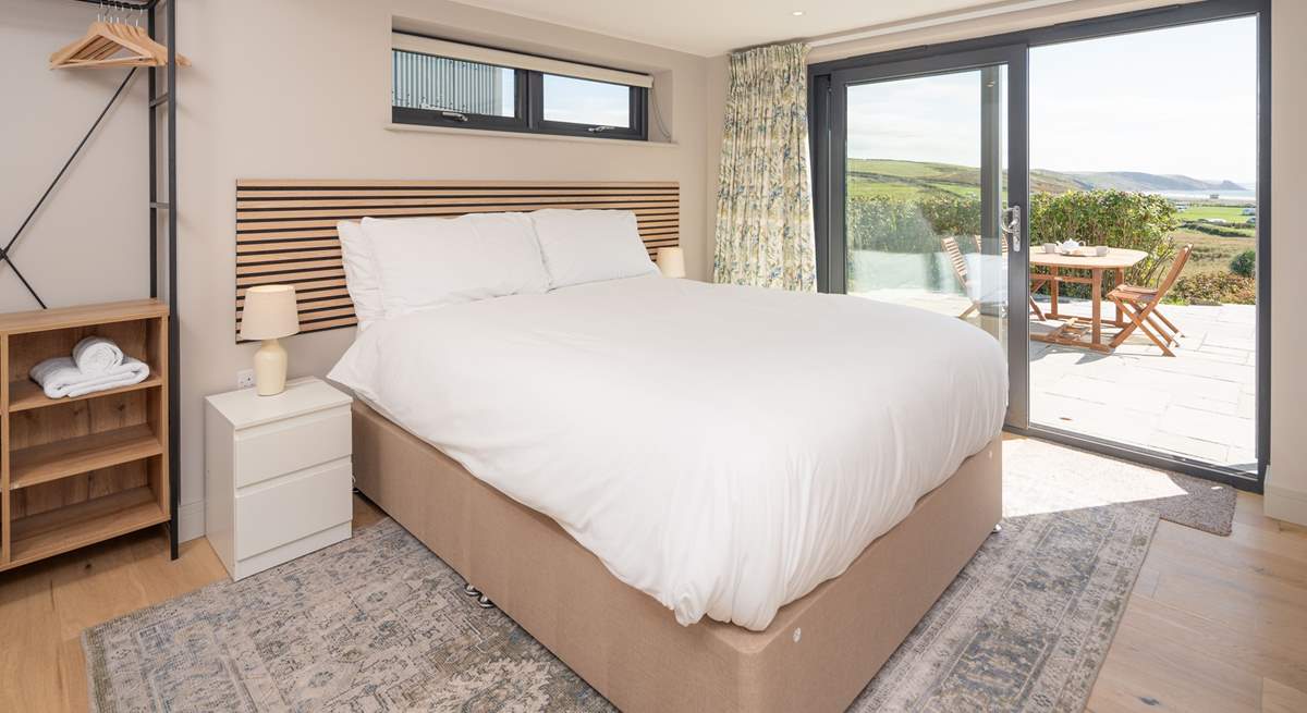 This lower ground floor bedroom has captivating sea views and access to the patio. Enjoy stargazing and watching the moonlight shimmering on the sea.