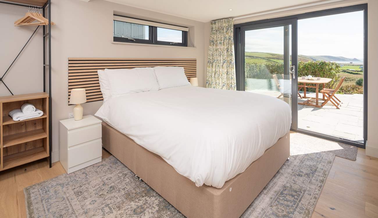 This lower ground floor bedroom has captivating sea views and access to the patio. Enjoy stargazing and watching the moonlight shimmering on the sea.