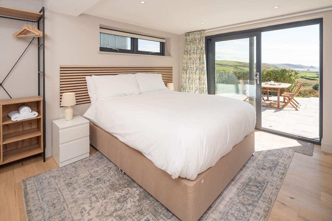 This lower ground floor bedroom has captivating sea views and access to the patio. Enjoy stargazing and watching the moonlight shimmering on the sea.