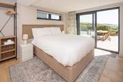 This lower ground floor bedroom has captivating sea views and access to the patio. Enjoy stargazing and watching the moonlight shimmering on the sea.