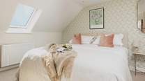 The tranquil bedroom offers the perfect spot to recharge. This bed can also be made up as a twin for flexibility.