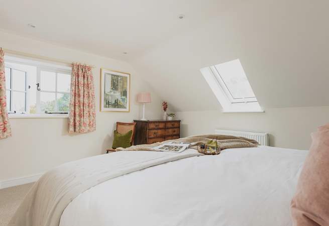 This double aspect bedroom has lovely rural views out across the garden.